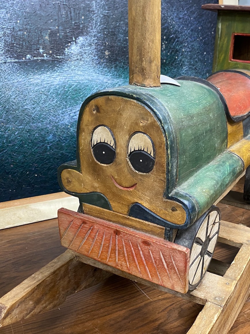 A child's carved wood rocking locomotive, length 80cm, height 59cm